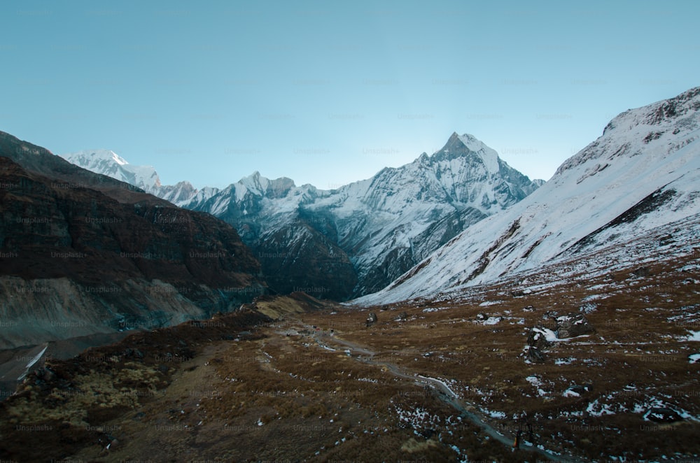 a view of a mountain range with snow on it