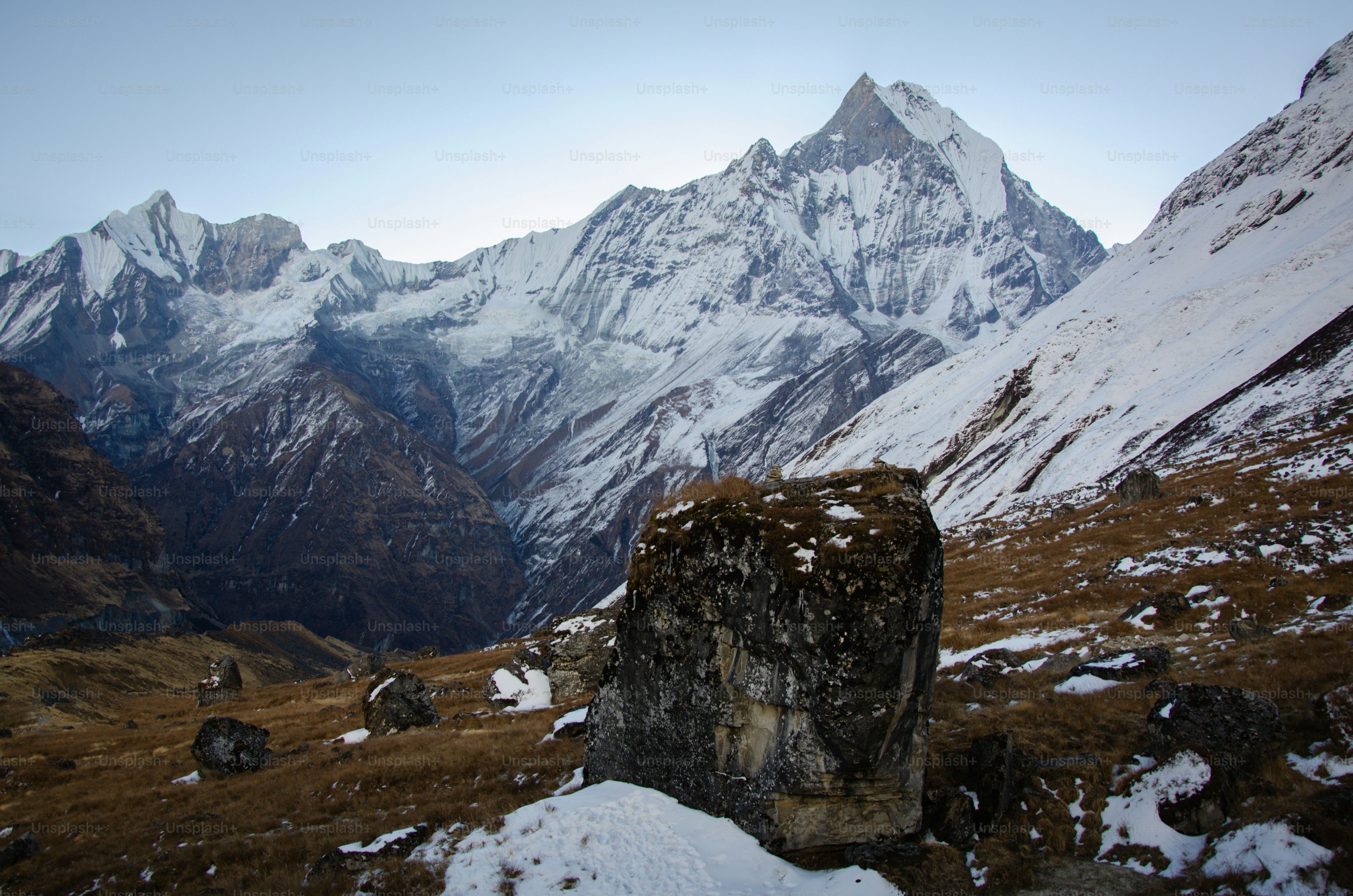 a rocky outcropping in front of a mountain range