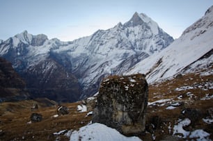 a rocky outcropping in front of a mountain range