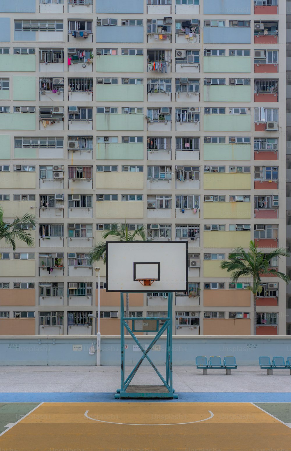 a basketball court in front of a tall building