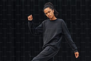 a woman in a black sweatshirt and sweat pants
