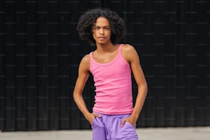 a young woman in a pink tank top and purple shorts