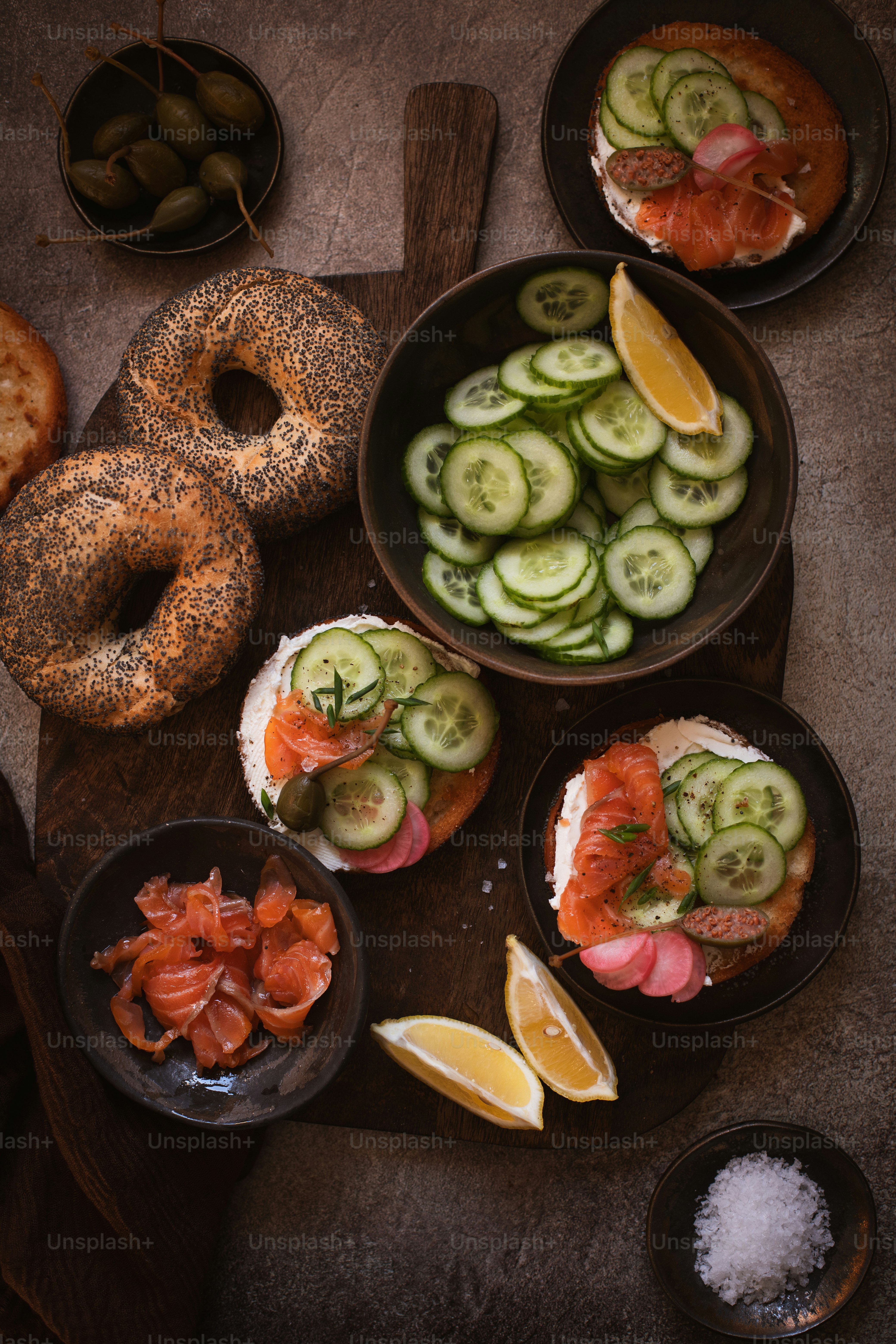 a table topped with plates of food next to a bagel