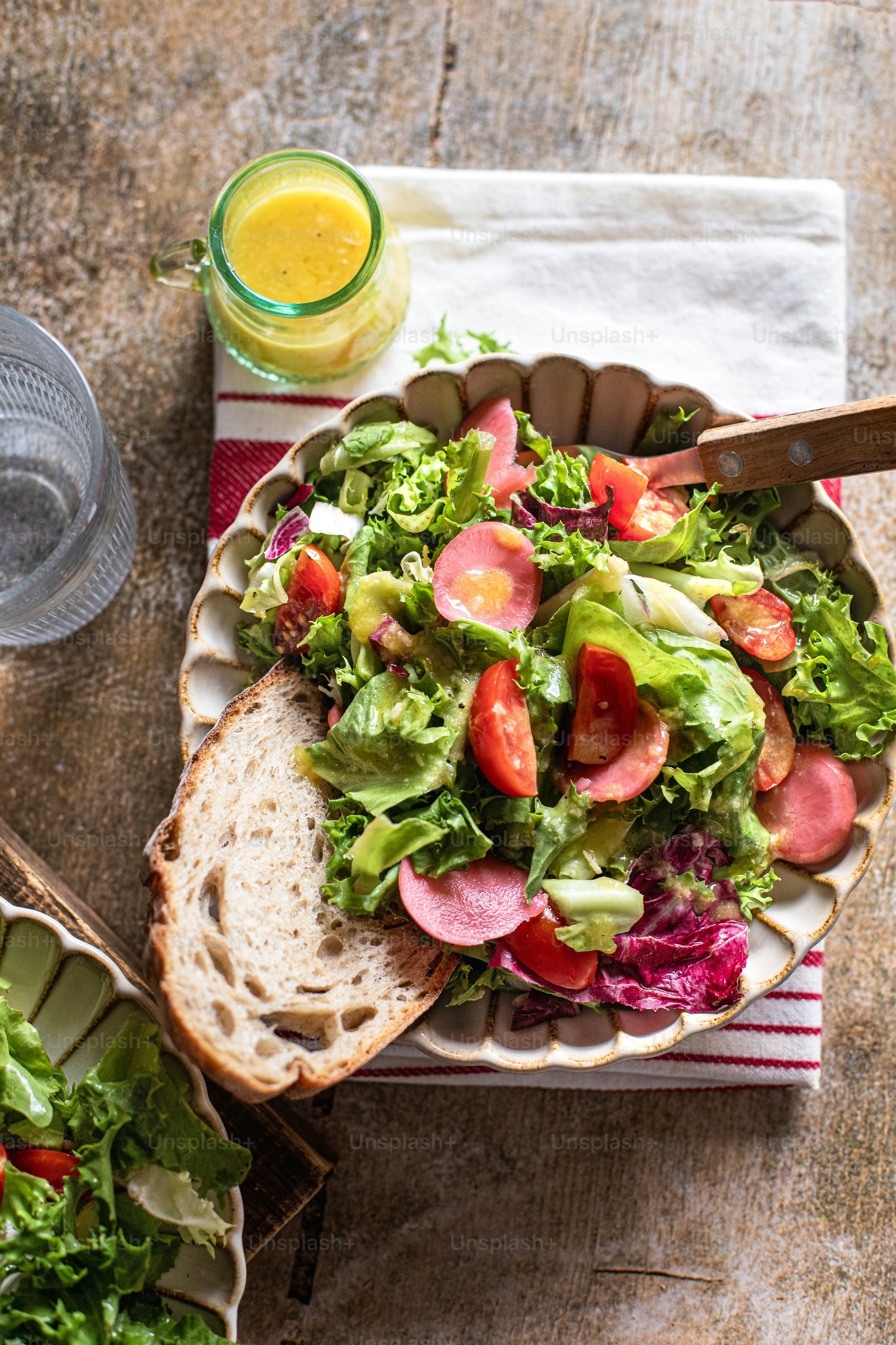 a bowl of salad and a glass of orange juice
