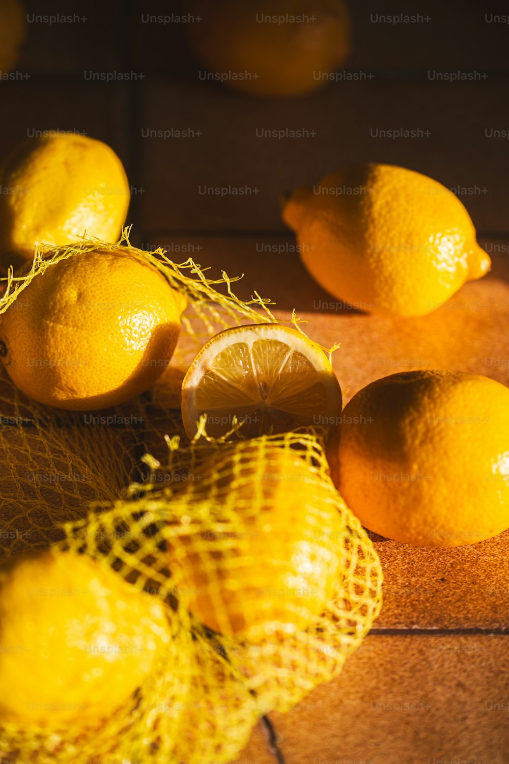 a pile of lemons sitting on top of a wooden table