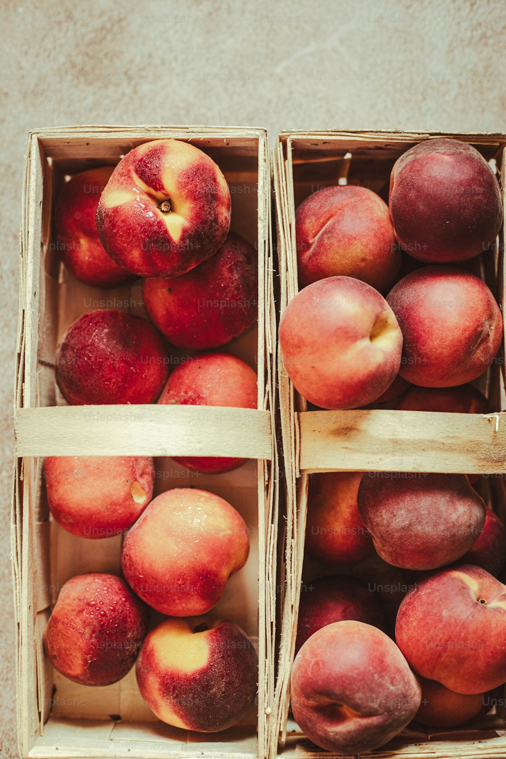 a couple of boxes filled with ripe peaches
