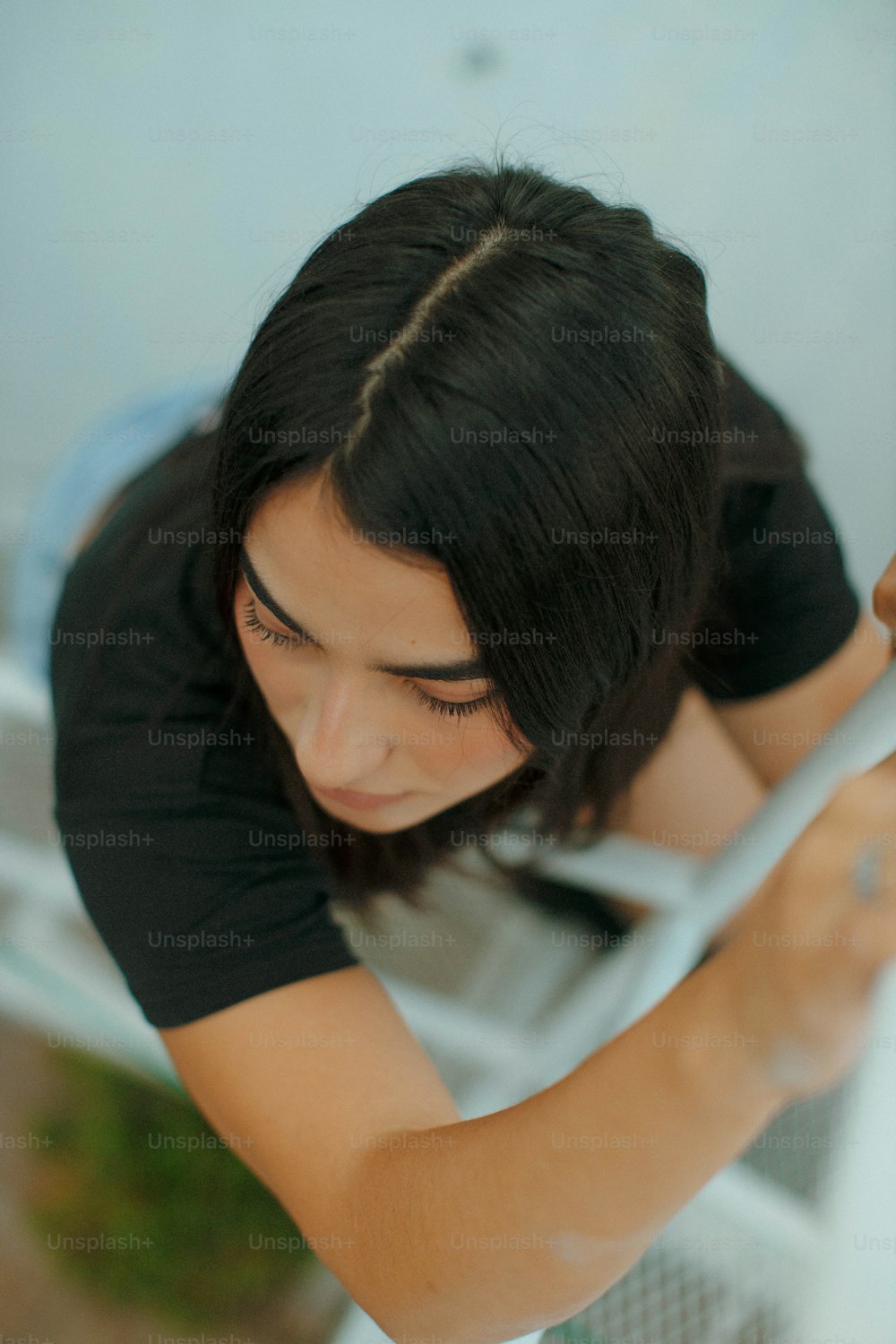 a woman holding a toothbrush in her right hand