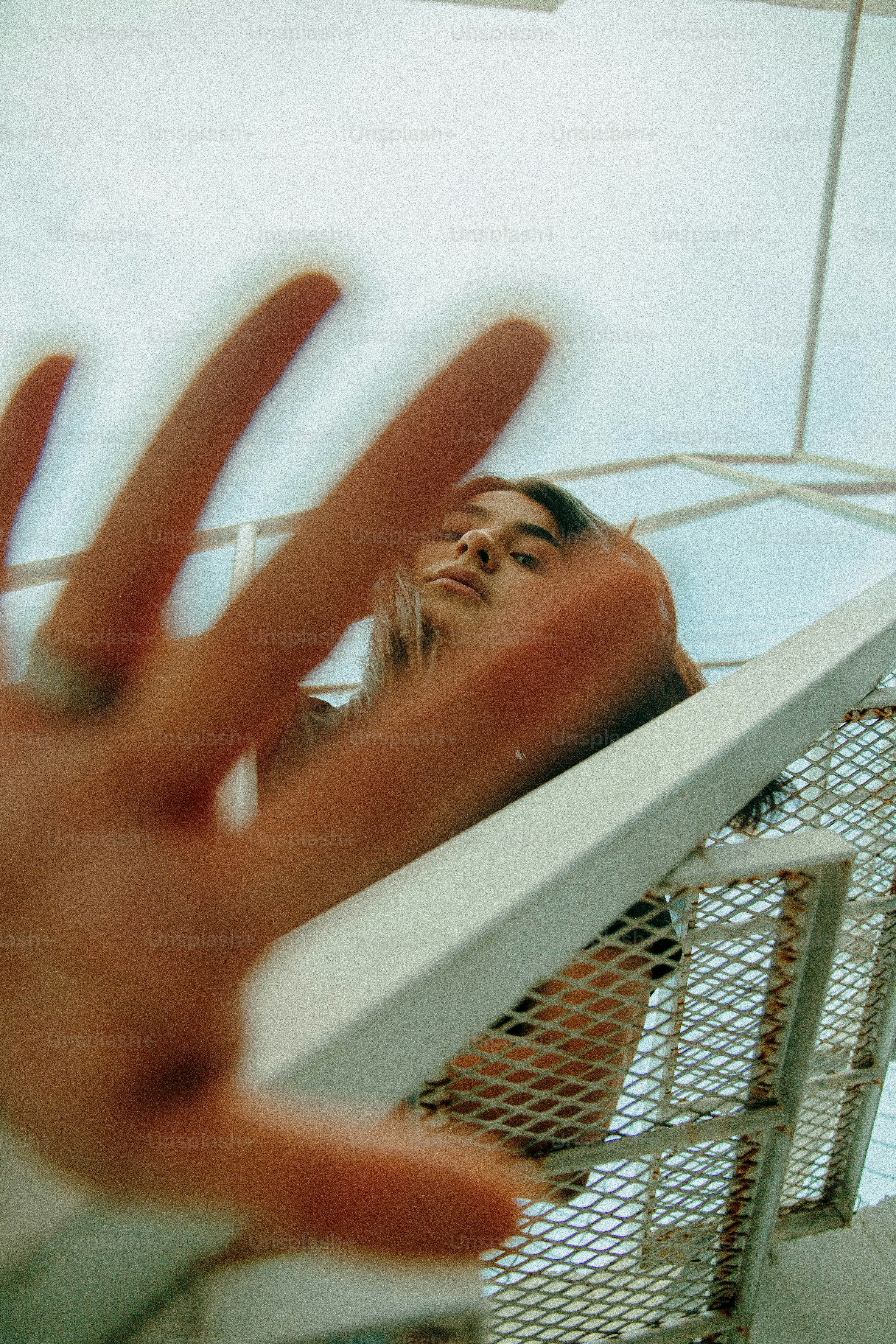 a woman standing on top of a boat holding her hand up