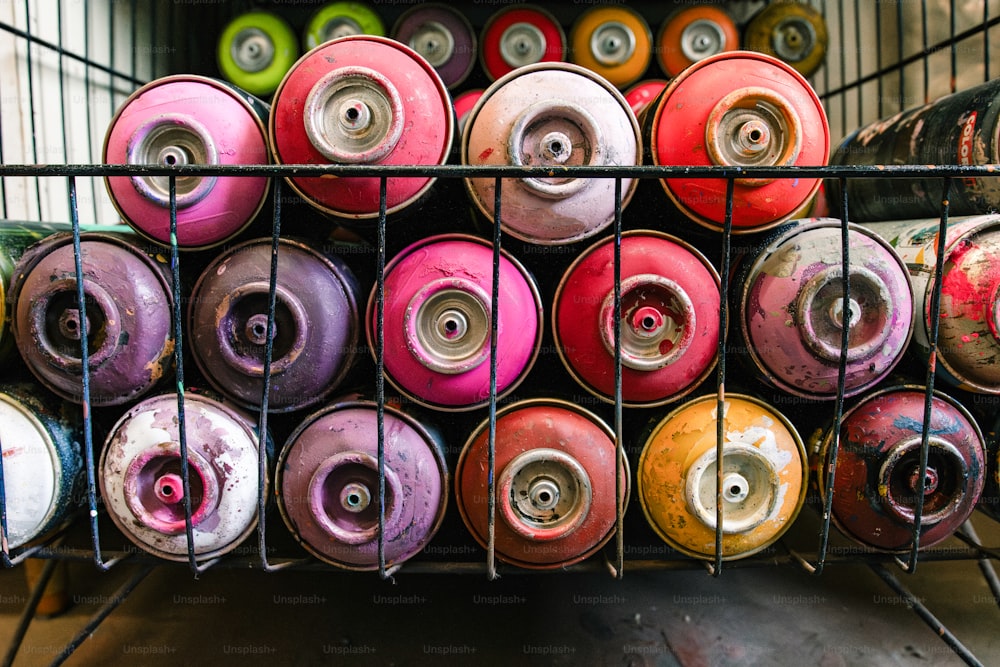 a rack full of different colored spray cans