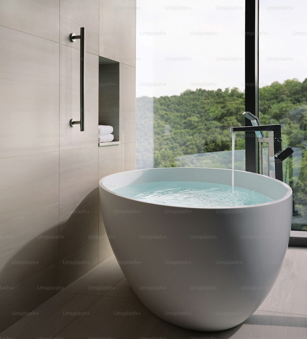 a large white bath tub sitting next to a window