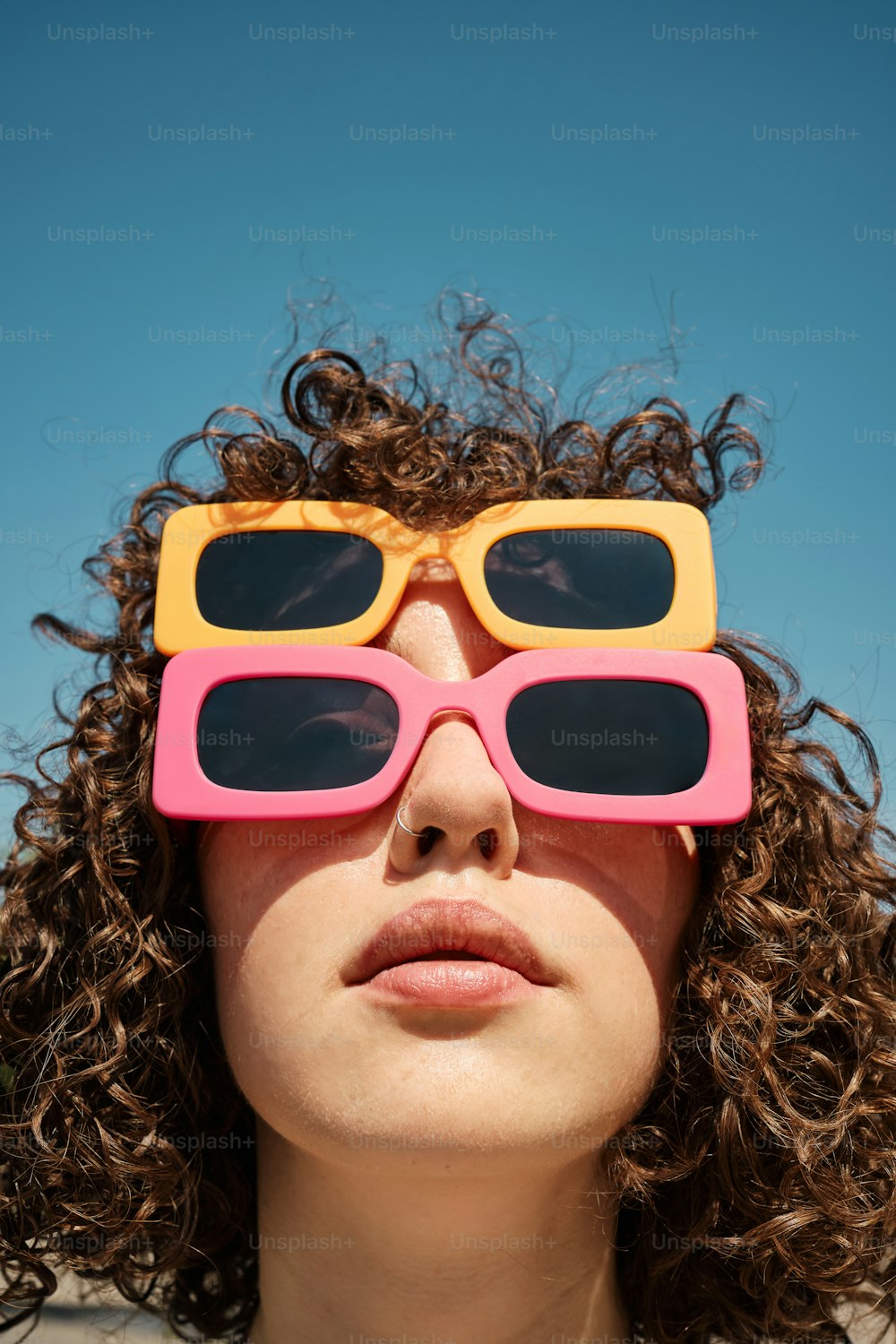 a woman with curly hair wearing a pair of 3d glasses