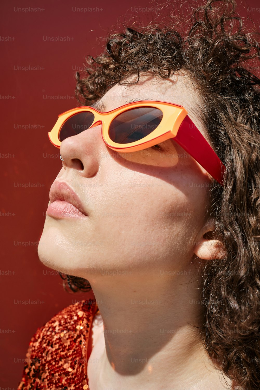 a woman wearing a pair of red and yellow sunglasses
