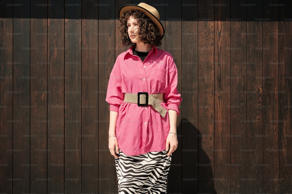 a woman in a pink shirt and zebra print skirt