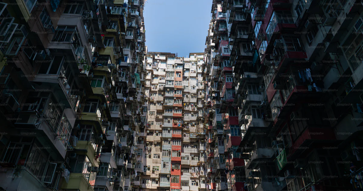 A very tall building with lots of windows and balconies photo – Hong ...