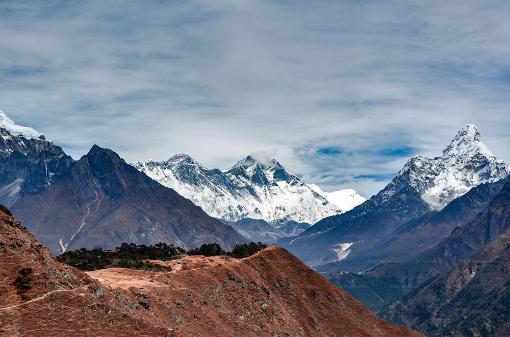 a mountain range with snow capped mountains in the background