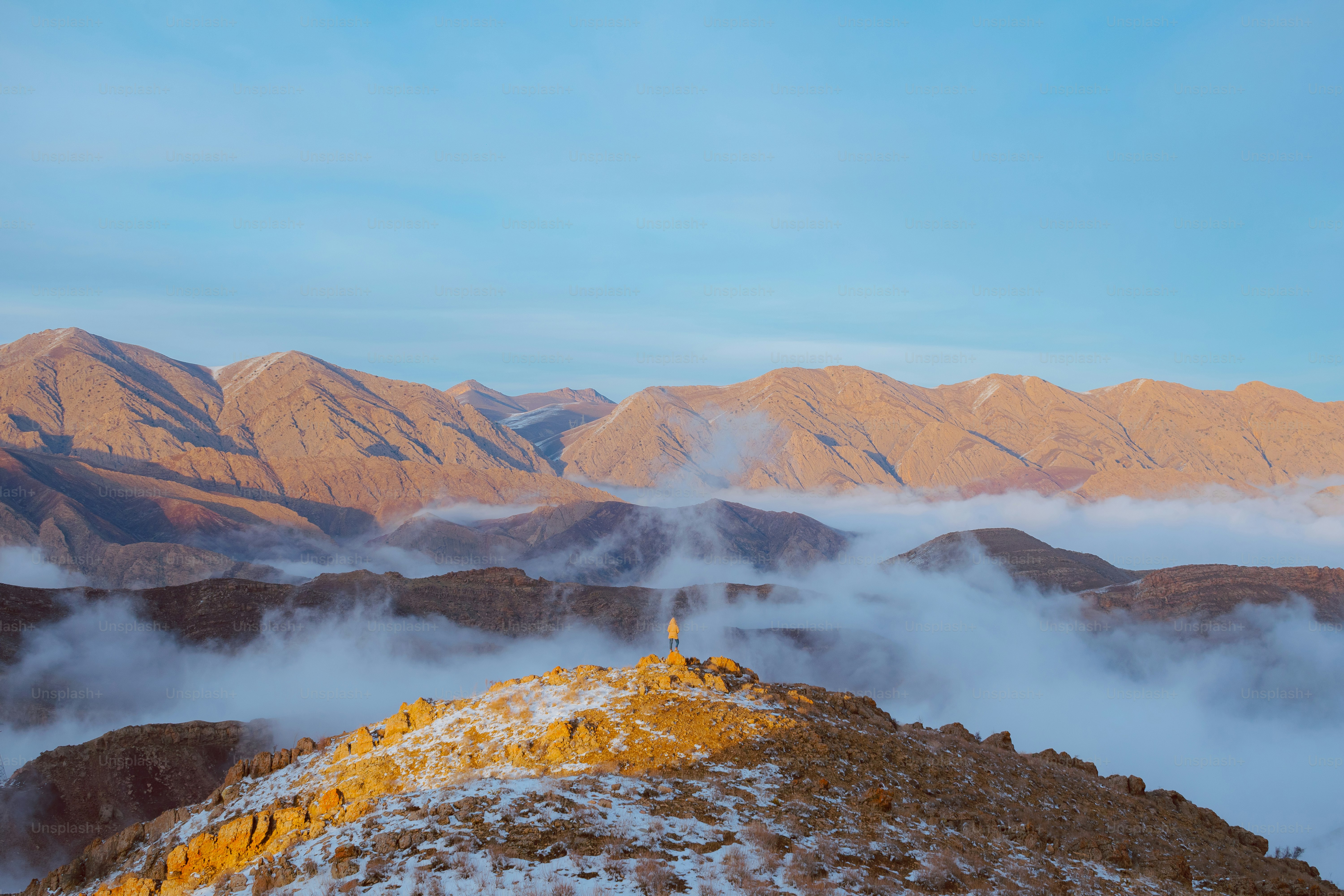 A view of a mountain range covered in snow photo – Sunset Image on Unsplash