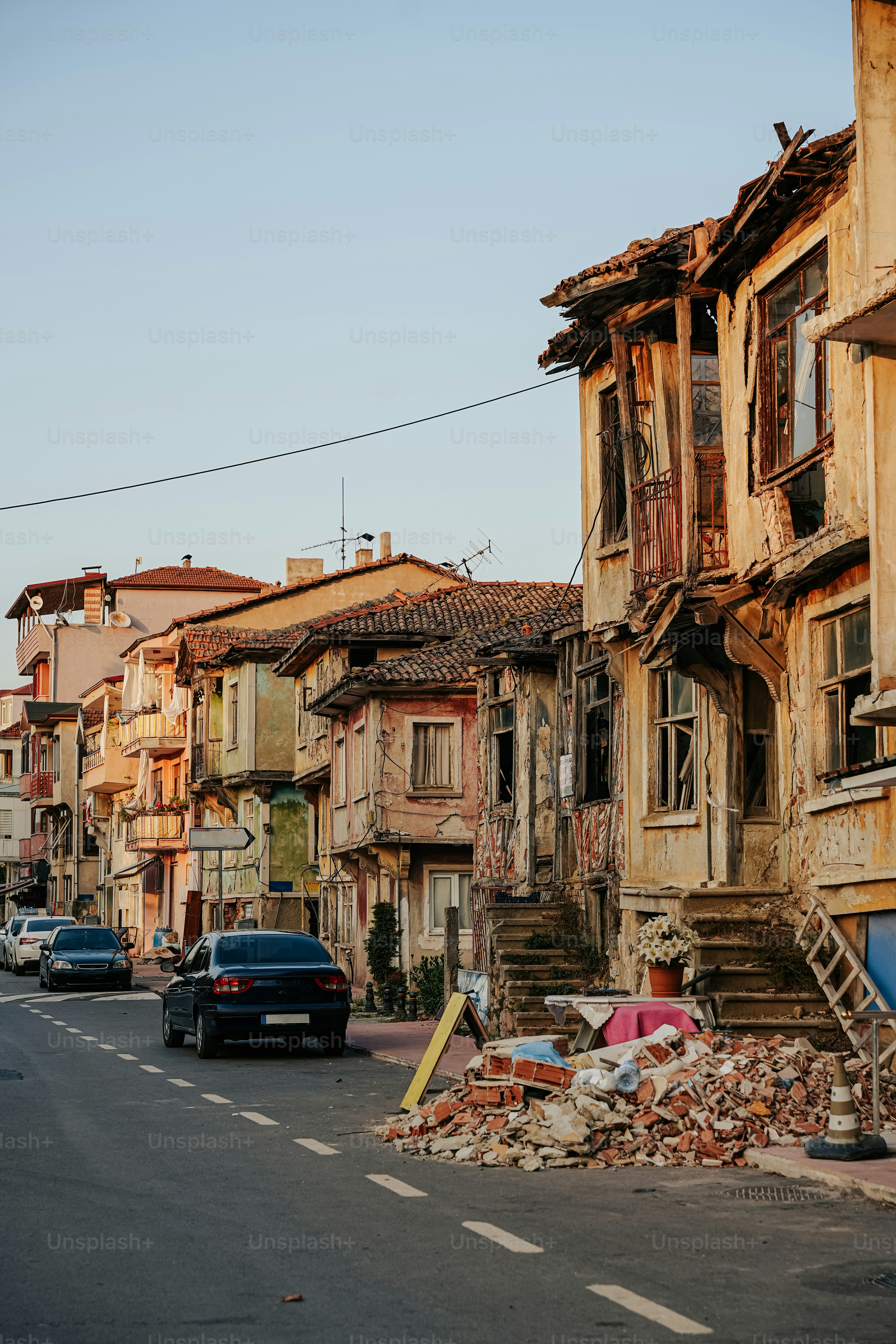 a car driving down a street next to a pile of rubble