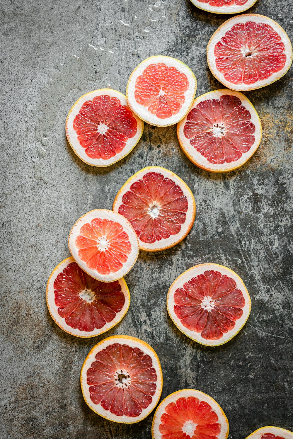 a bunch of grapefruit cut in half on a table