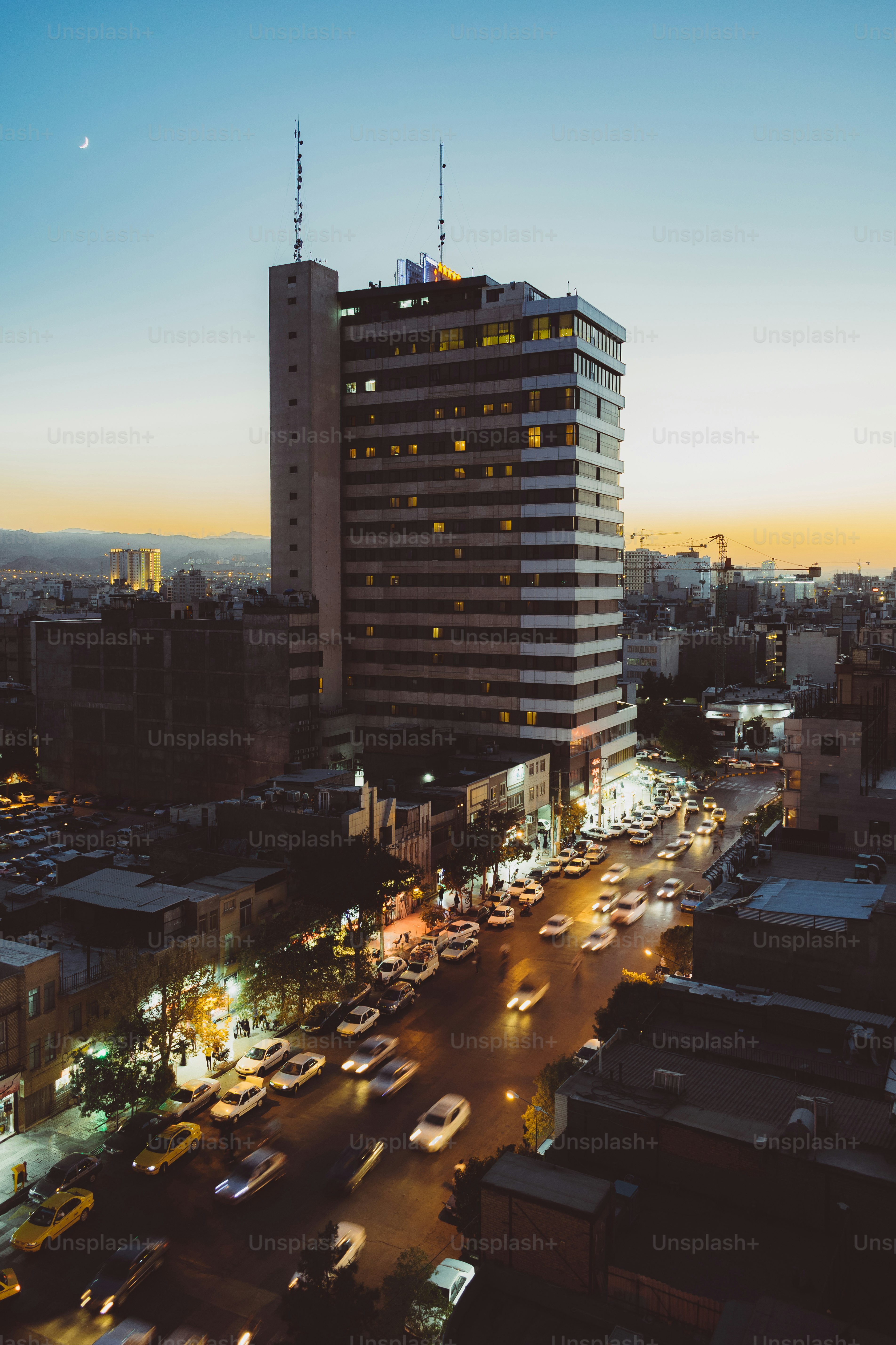 a city street filled with lots of traffic next to tall buildings