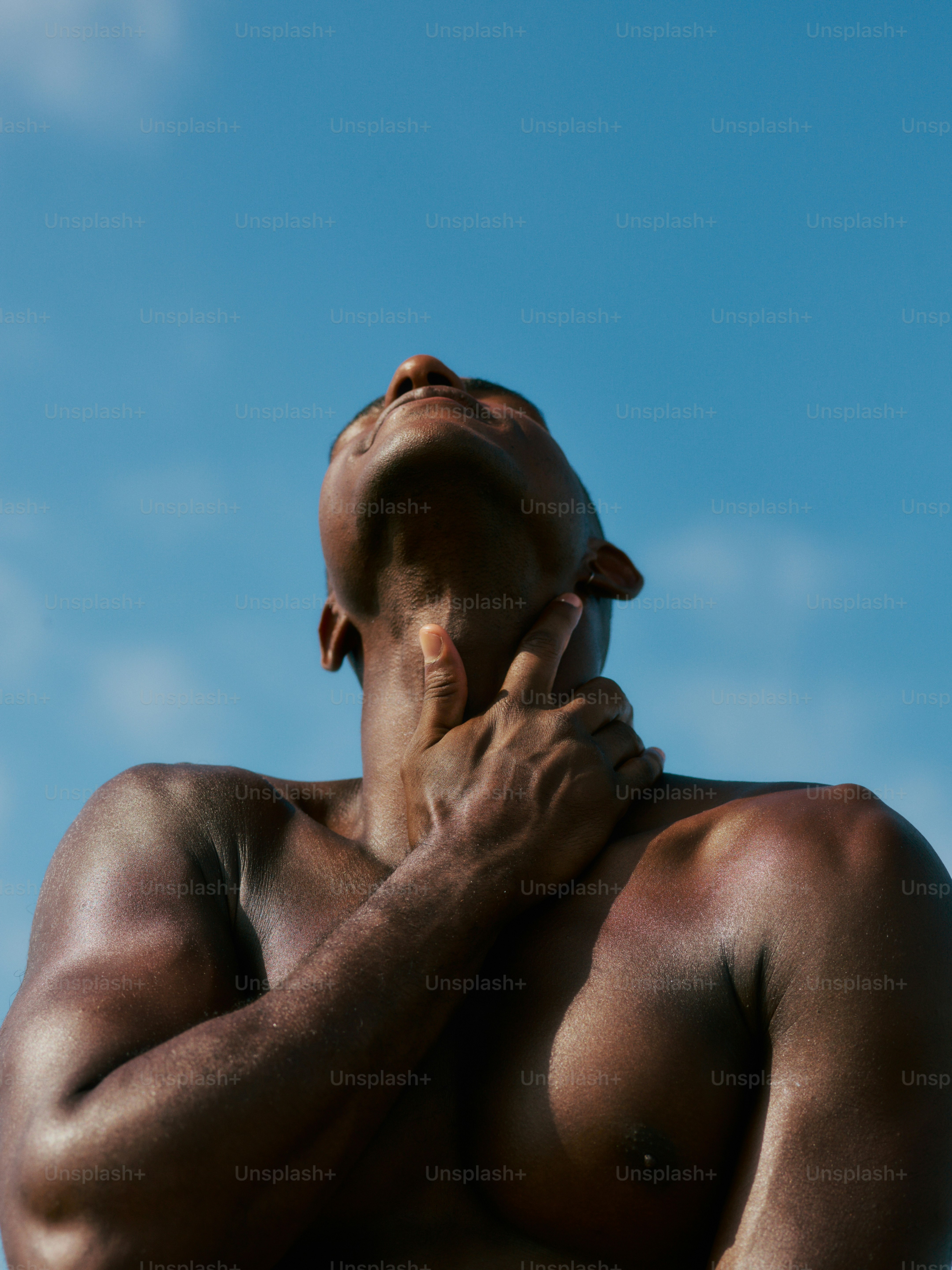 a shirtless man with his hands on his chest