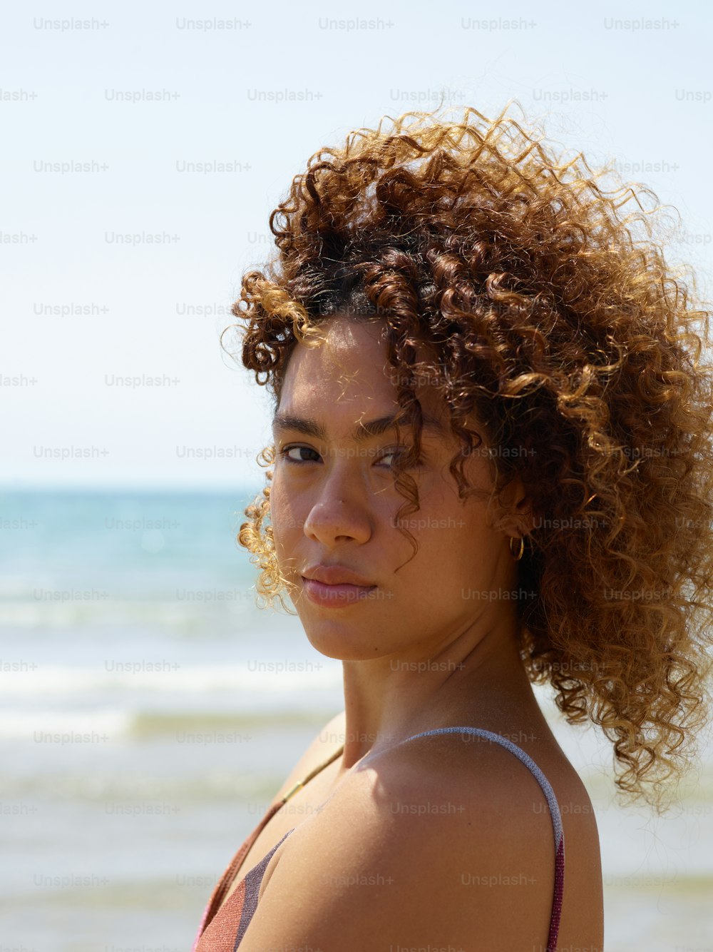 a close up of a person near the ocean