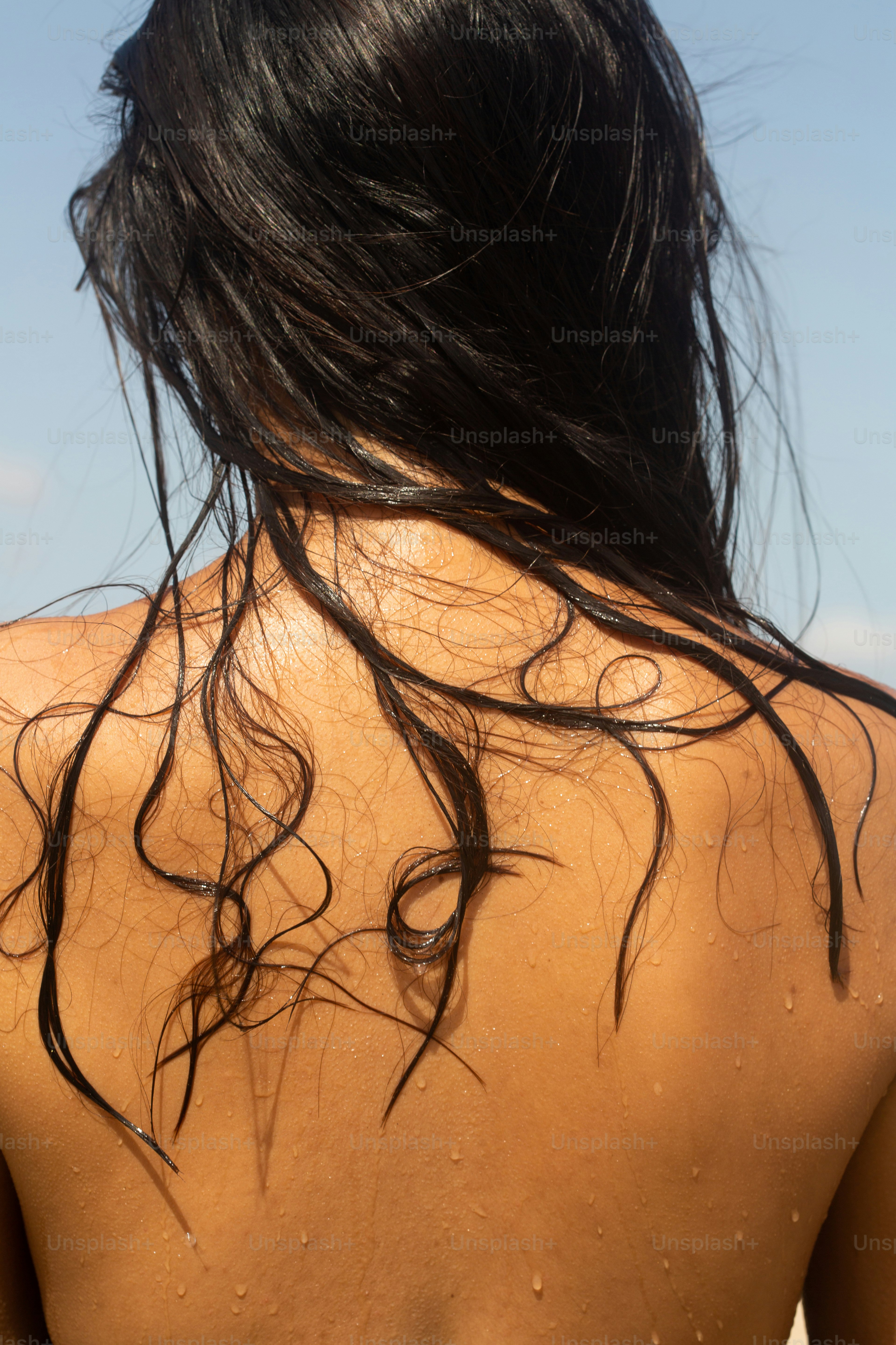 the back of a woman's head with wet hair