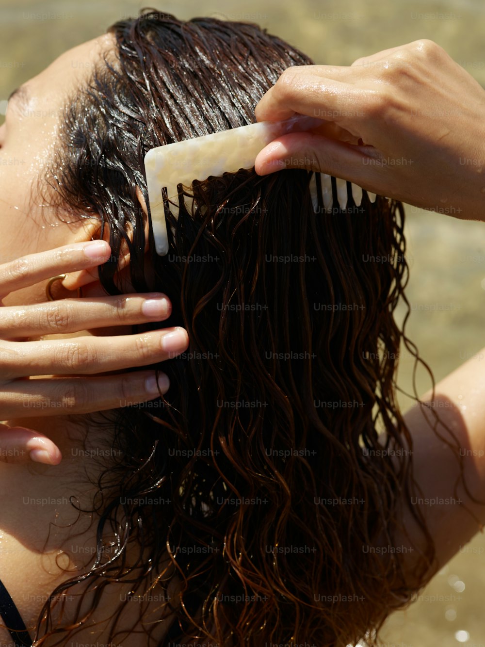 a close up of a person brushing their hair