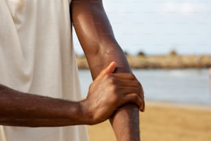 a close up of a person holding his arm