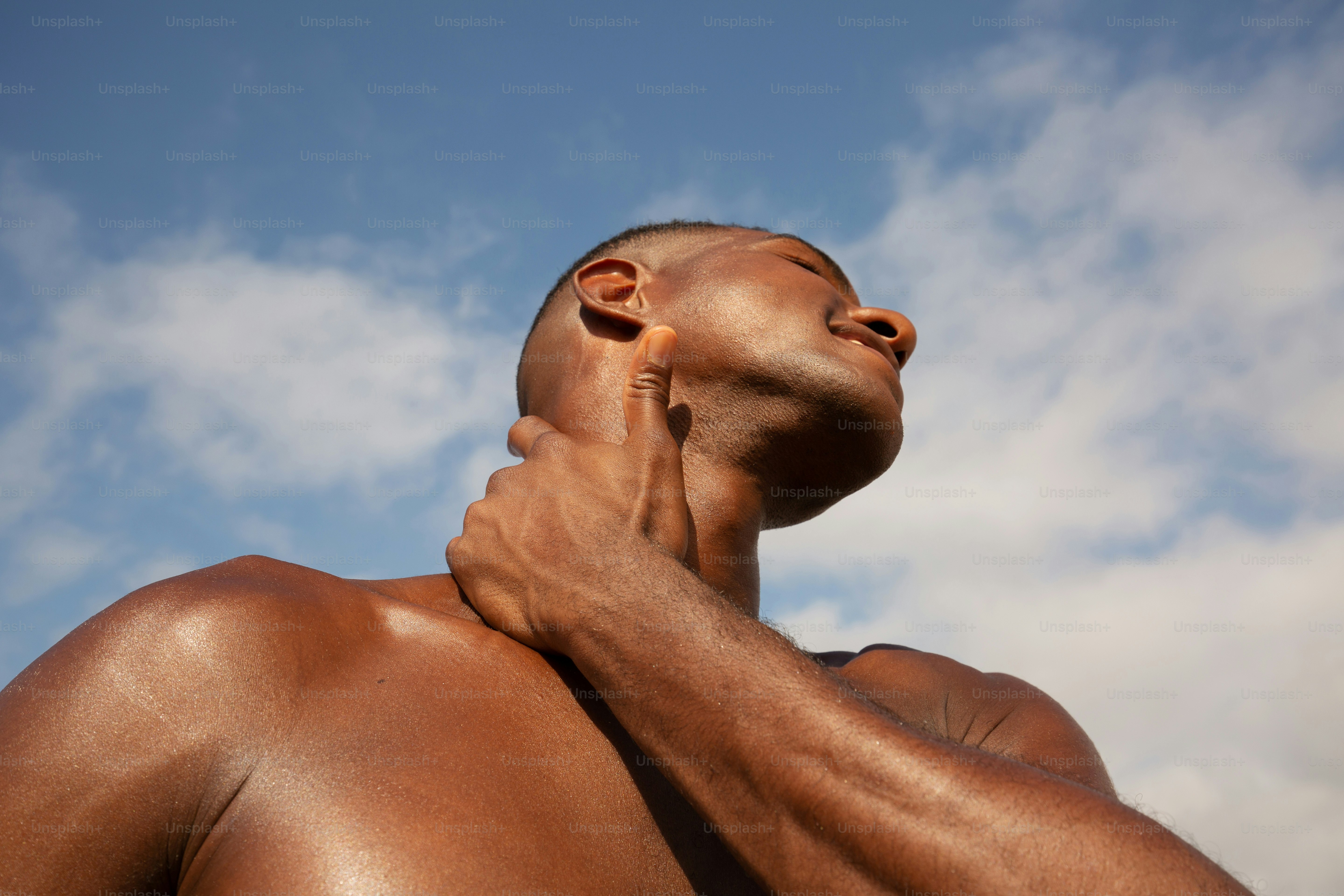 a man that is standing up with his neck up