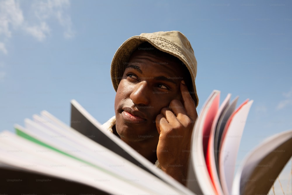 a man is holding a book and talking on the phone