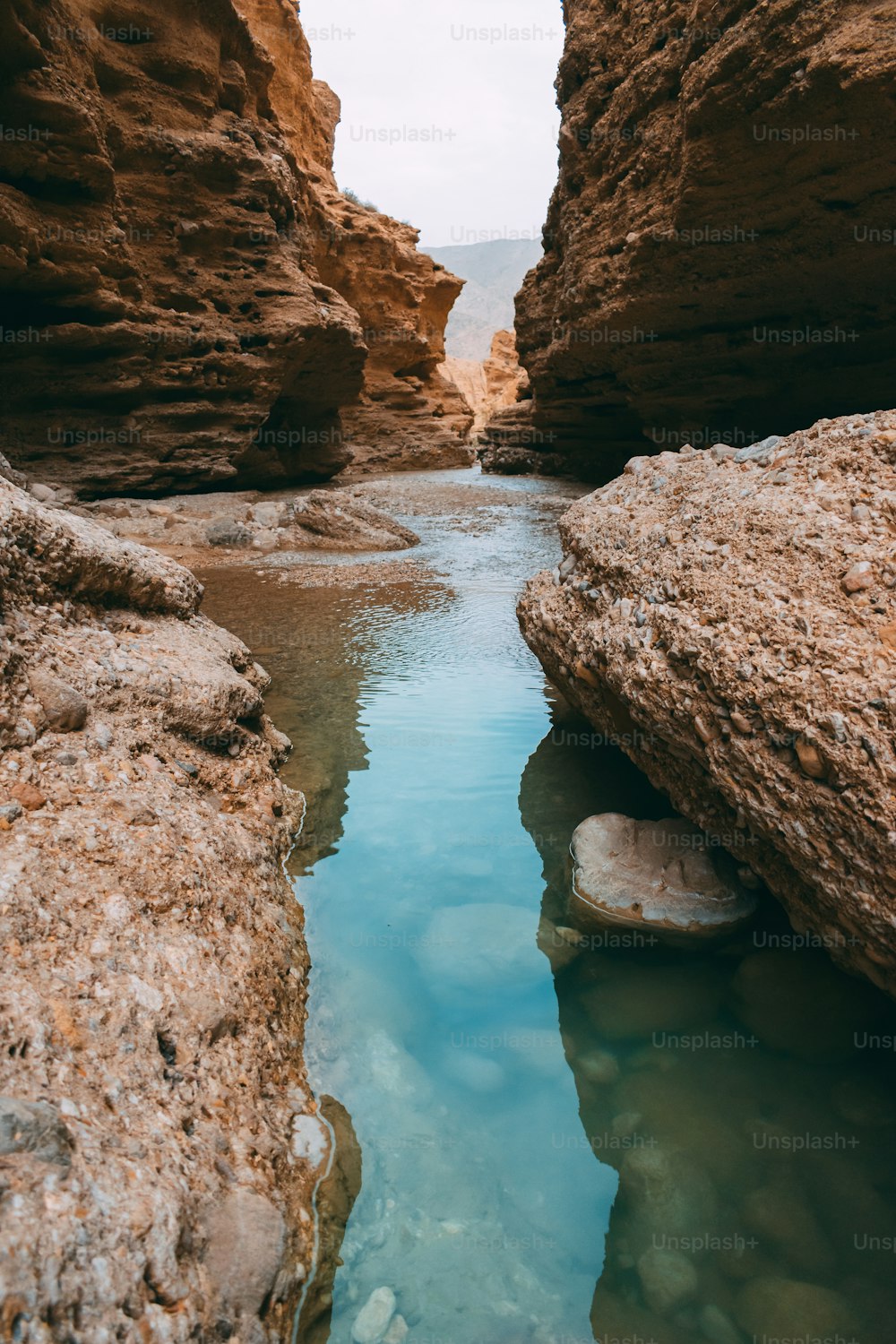 a narrow river running through a rocky canyon