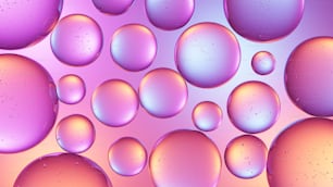 Un primer plano de un montón de burbujas sobre un fondo rosa