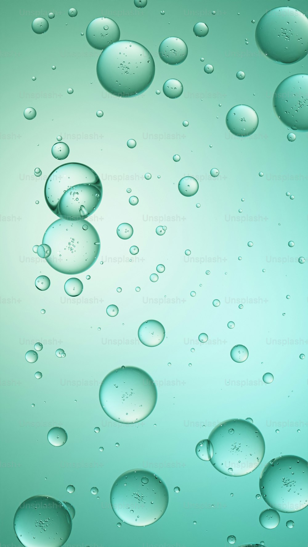 a bunch of water droplets on a green background