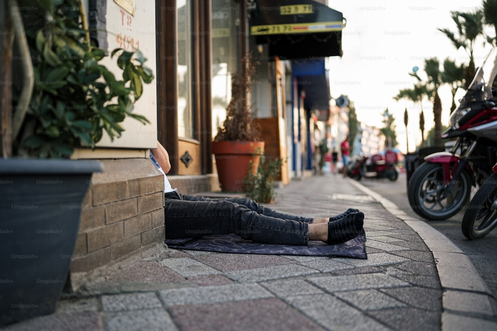 a woman laying on the ground next to a motorcycle