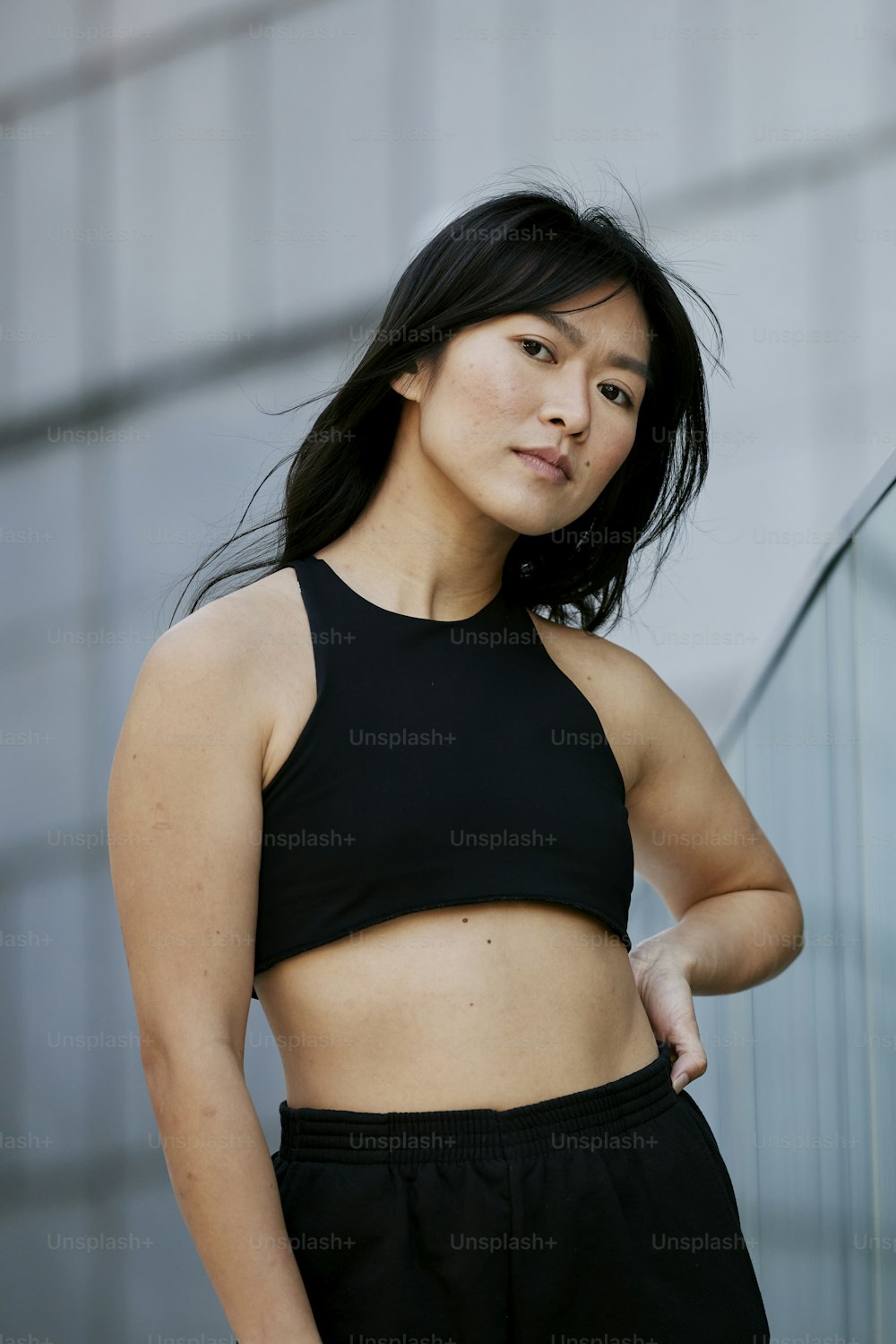 a woman in a black crop top posing for a picture