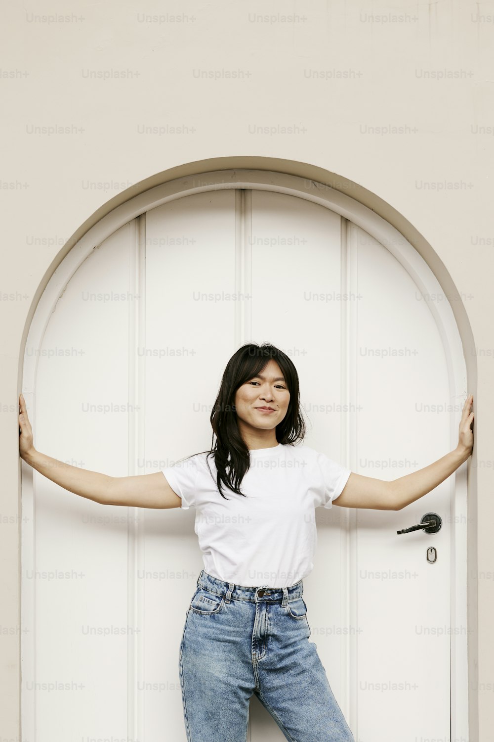 a woman standing in front of a white door