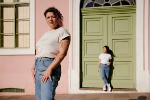 a woman standing in front of a green door