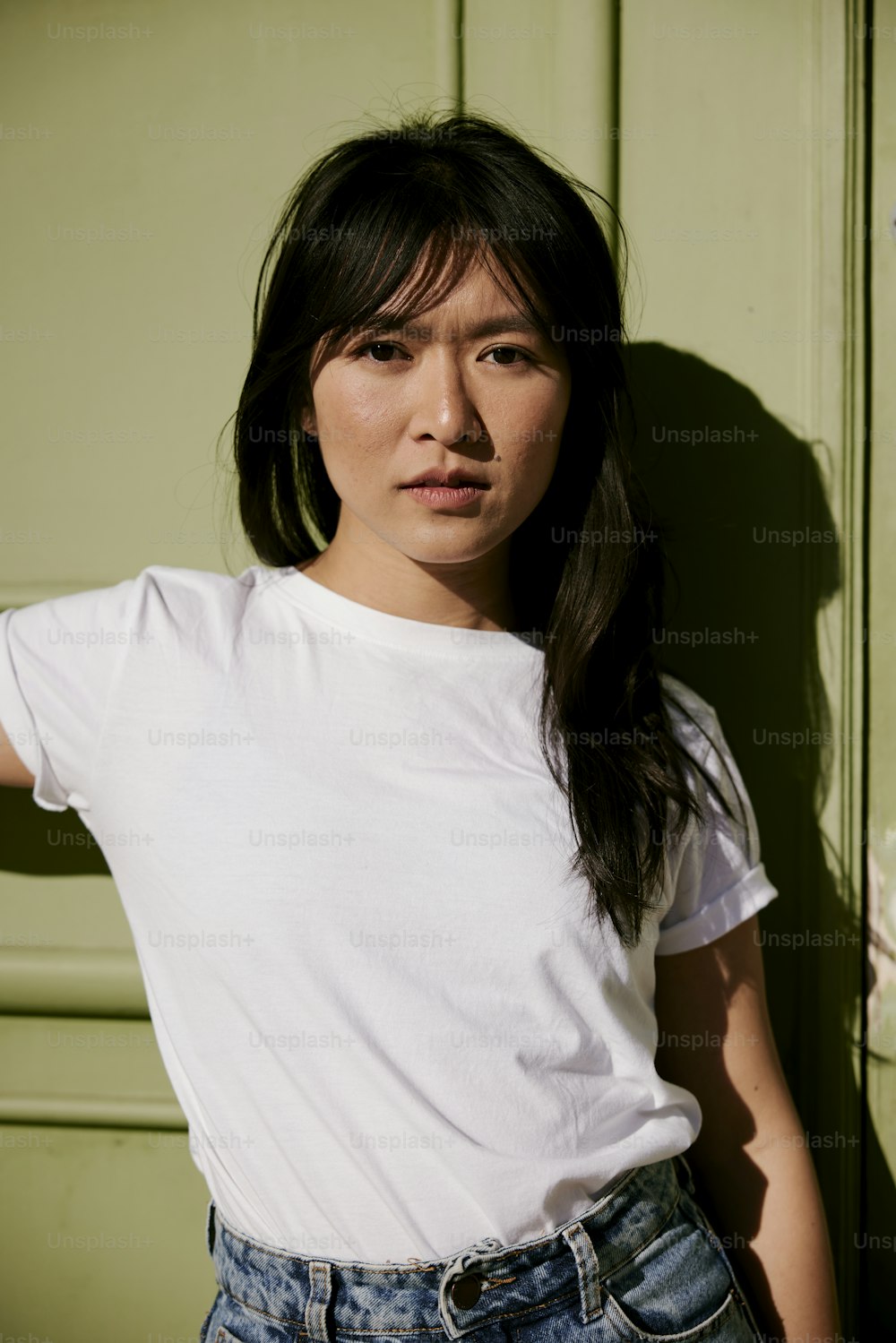 a woman standing in front of a green door