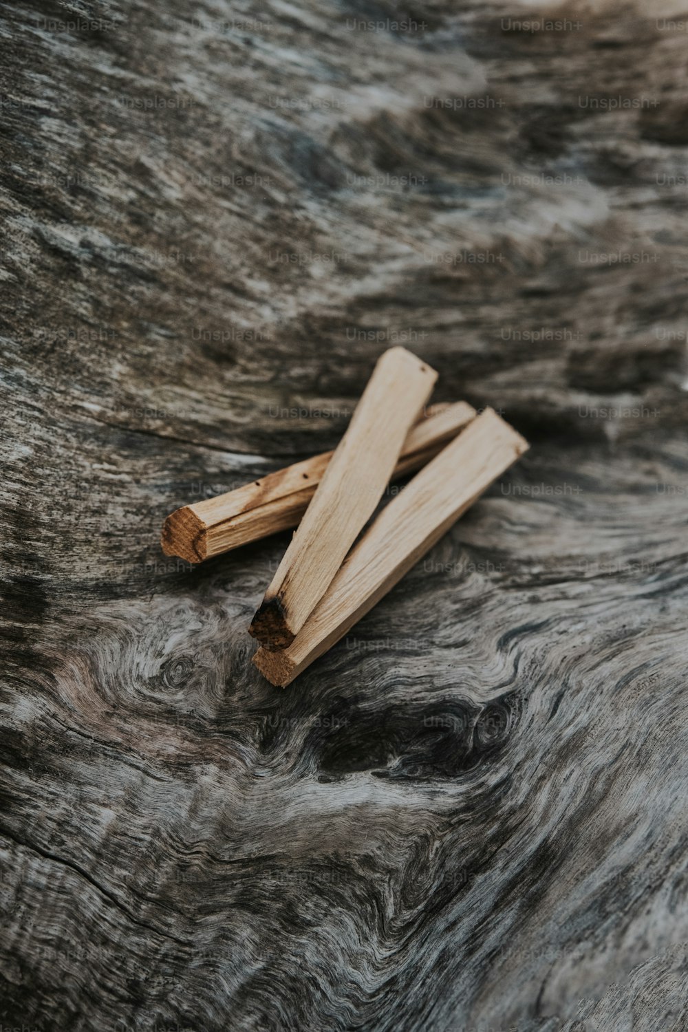 a couple of wooden sticks laying on top of a fur covered surface