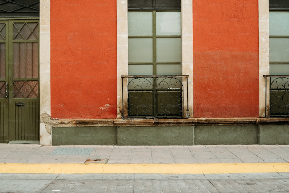 a red building with a green door and window