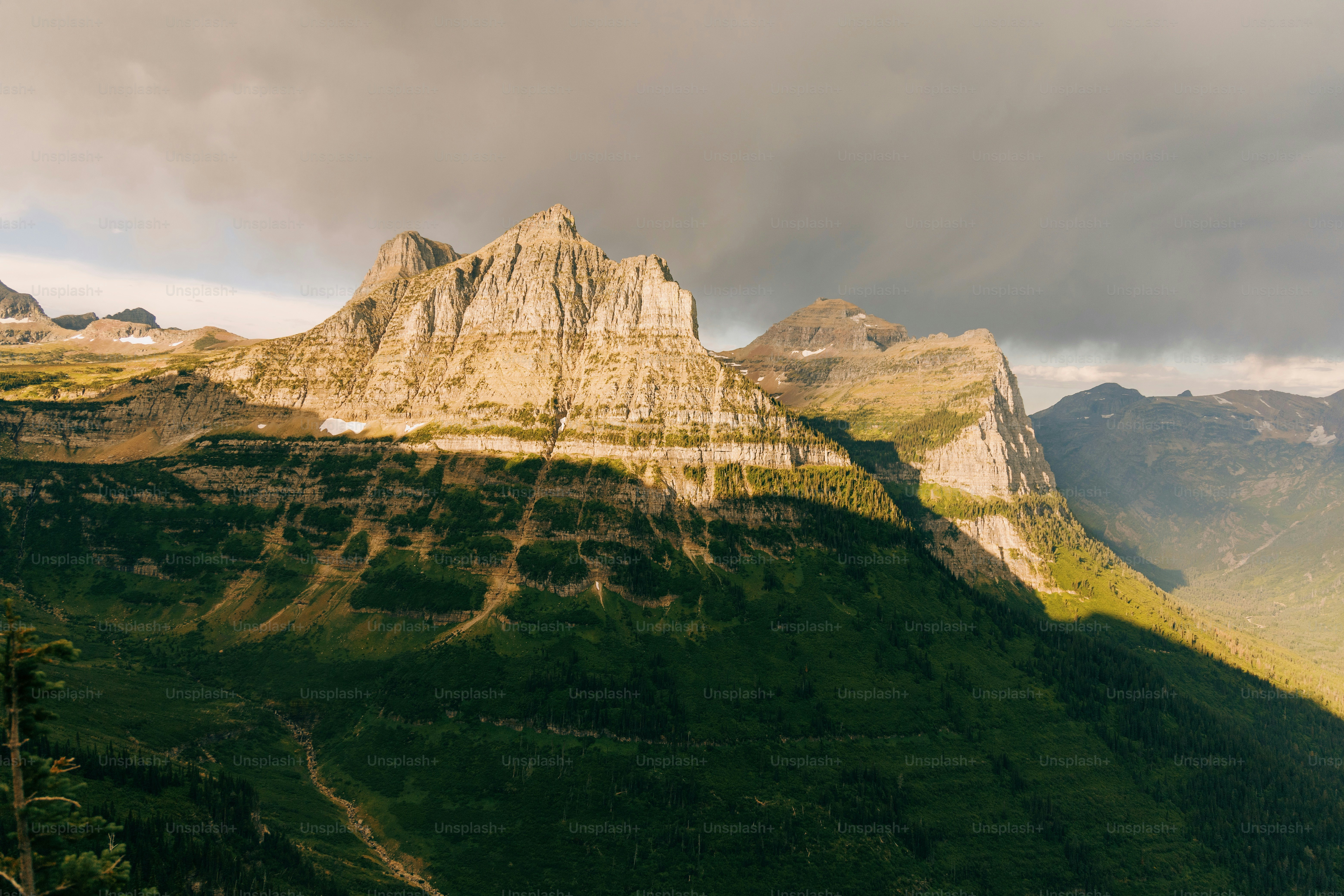 a view of a mountain range with a cloudy sky