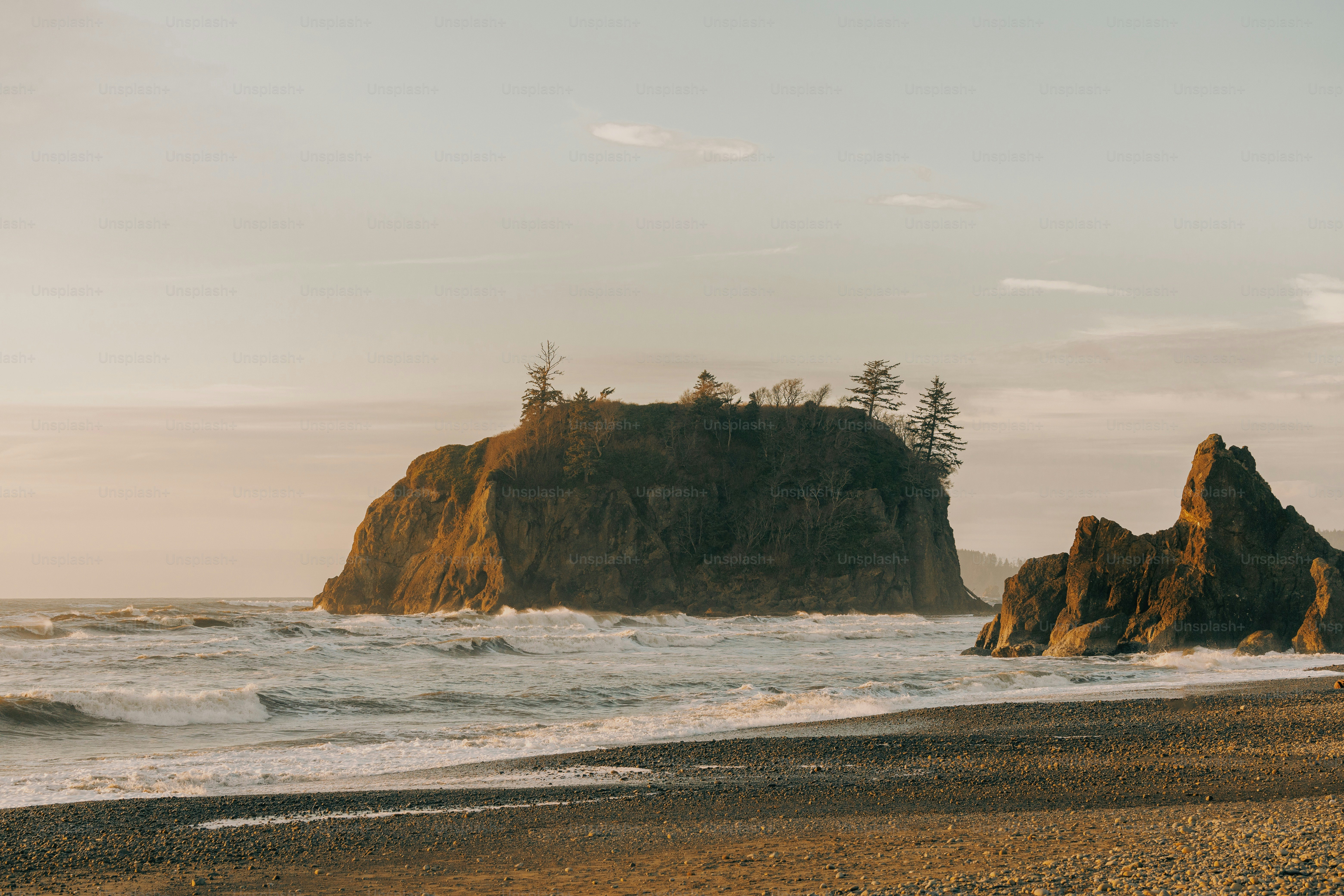 a couple of large rocks sitting on top of a beach