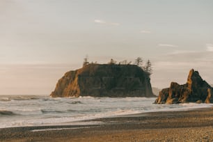 a couple of large rocks sitting on top of a beach