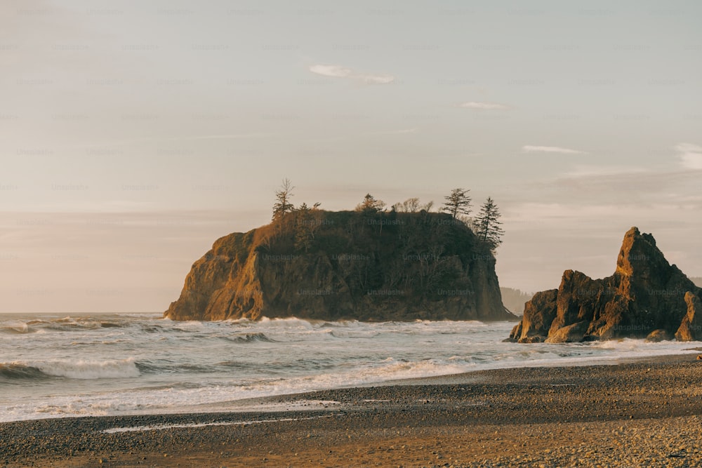 un paio di grandi rocce sedute sulla cima di una spiaggia