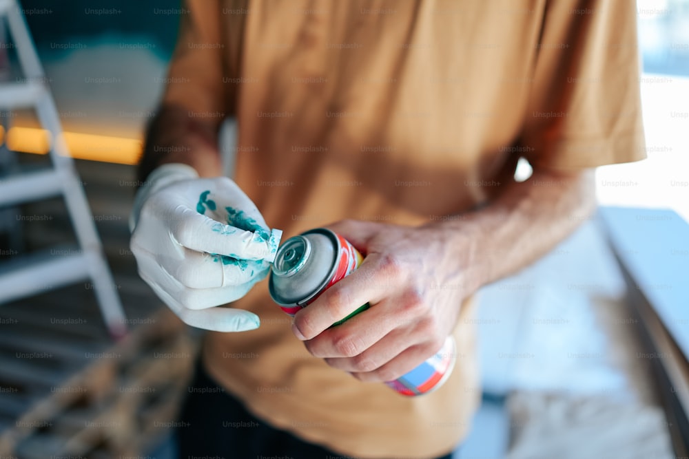 a person holding a spray bottle in their hand