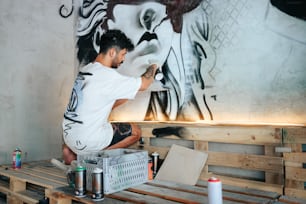 a man is painting a mural on a wall