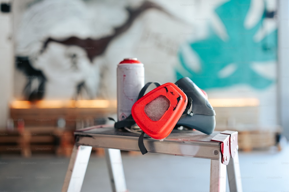 a red and black object sitting on top of a metal table