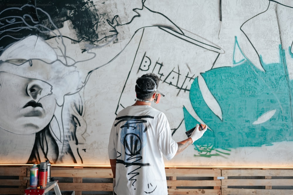 a man standing in front of a large painting