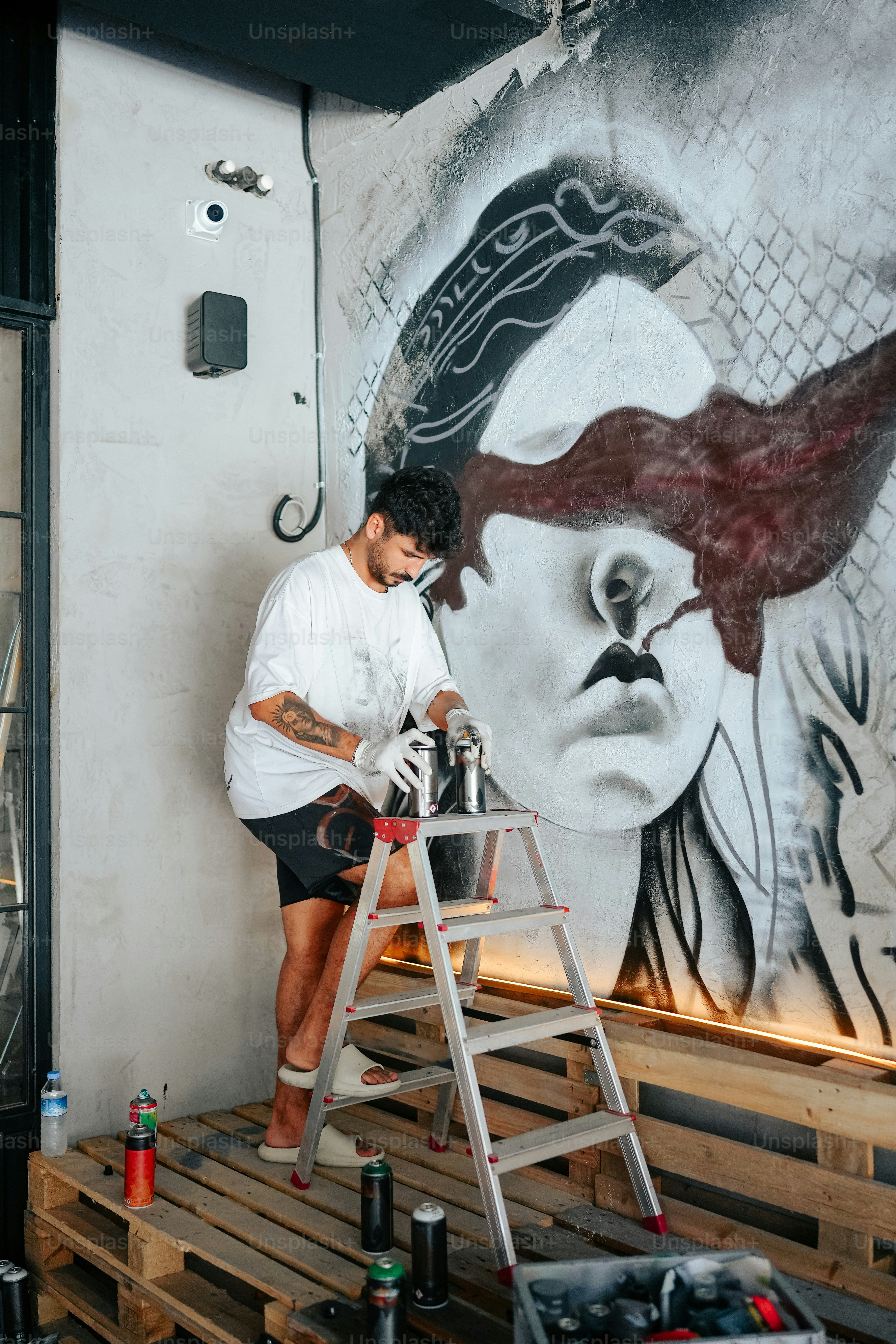 A man is painting a mural on a wall photo – Graffiti Image on Unsplash