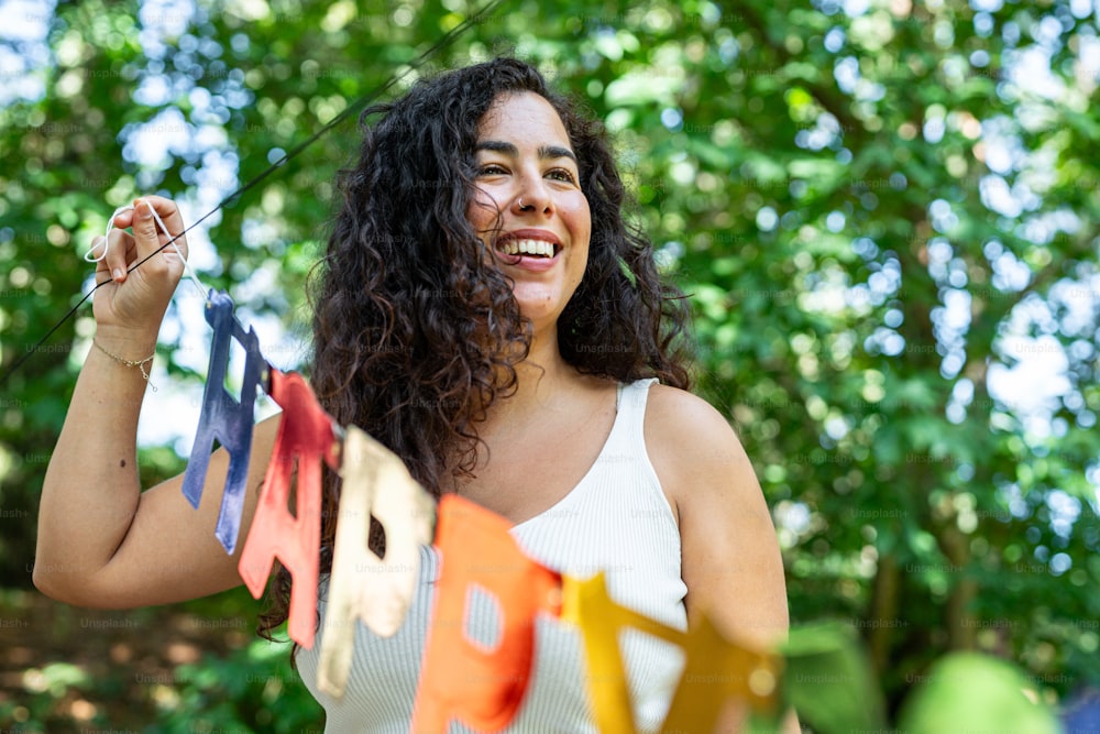 a woman holding a string of colorful kites